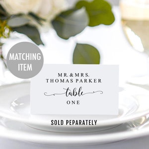 May include: White table number card with black text that reads "Mr. & Mrs. Thomas Parker table one".