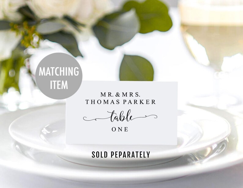 May include: White table number card with black text that reads "Mr. & Mrs. Thomas Parker table one".