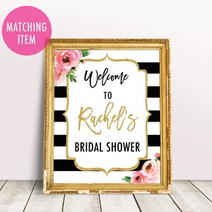 May include: Black and white striped bridal shower sign with gold glitter accents and pink flowers. The sign says "Welcome to Rachel's Bridal Shower".