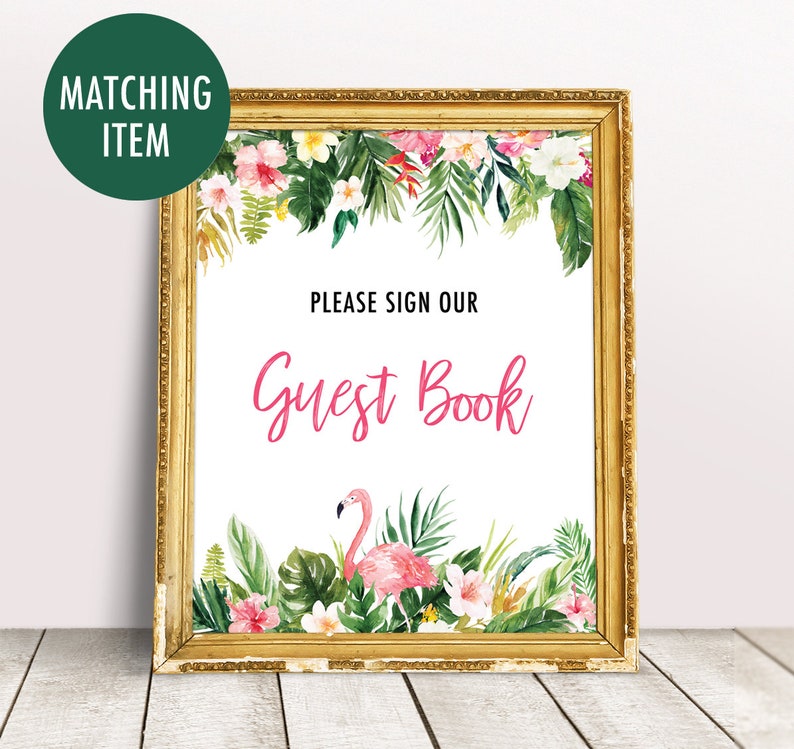 May include: A gold framed sign with a tropical floral border and a pink flamingo. The sign says "Please sign our Guest Book".