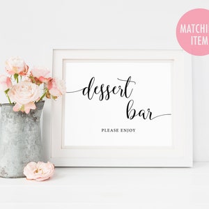 May include: White framed sign with black calligraphy that reads "dessert bar" and "please enjoy".