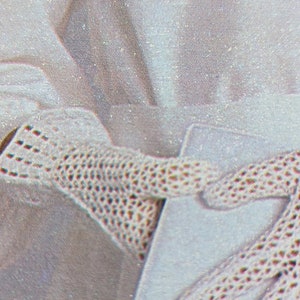 May include: A pair of white crocheted gloves with a delicate pattern. The gloves are made of a fine, lightweight material and have a soft, comfortable feel.