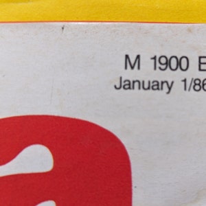 May include: Close-up of a white paper with black text. The text reads "M 1900 E January 1/86".
