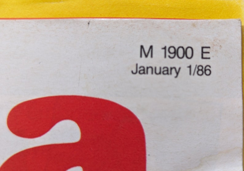 May include: Close-up of a white paper with black text. The text reads "M 1900 E January 1/86".