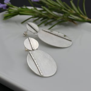 Organic silver oval earrings with hammered elements, Shiny and brushed finish. Made to order