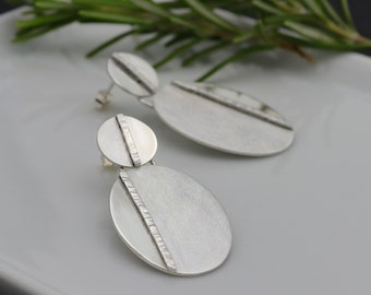 Organic silver oval earrings with hammered elements, Shiny and brushed finish. Made to order