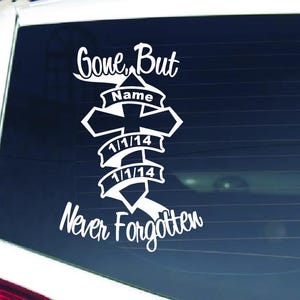 May include: White vinyl decal applied to a car window. The decal reads "Gone, But Never Forgotten" with a cross and dates 1/1/14. A space is provided for a name. The decal is designed to be applied to a vehicle's rear window.