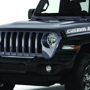 May include: A black Jeep Wrangler with a custom text decal on the hood that says "CUSTOM TEXT".