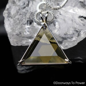 May include: A silver chain necklace with a large, faceted, golden-brown crystal pendant in the shape of a Star of David.