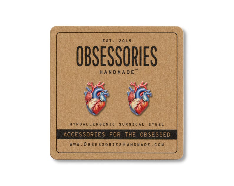 May include: A pair of anatomical heart stud earrings on a brown card. The earrings are red, blue, and white. The card has the text "OBSESSORIES HANDMADE" and "ACCESSORIES FOR THE OBSESSED".