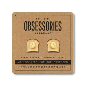 May include: Novelty stud earrings, each shaped like a slice of toast with butter. The earrings are presented on a brown card with the text "OBSESSORIES HANDMADE" and "ACCESSORIES FOR THE OBSESSED".