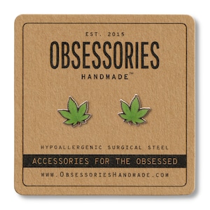 May include: A pair of green marijuana leaf earrings on a brown card with the text "OBSESSORIES HANDMADE" and "ACCESSORIES FOR THE OBSESSED".