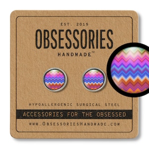 May include: A pair of stud earrings with a colorful chevron pattern. The earrings are made of hypoallergenic surgical steel and are labeled "OBSESSORIES HANDMADE".