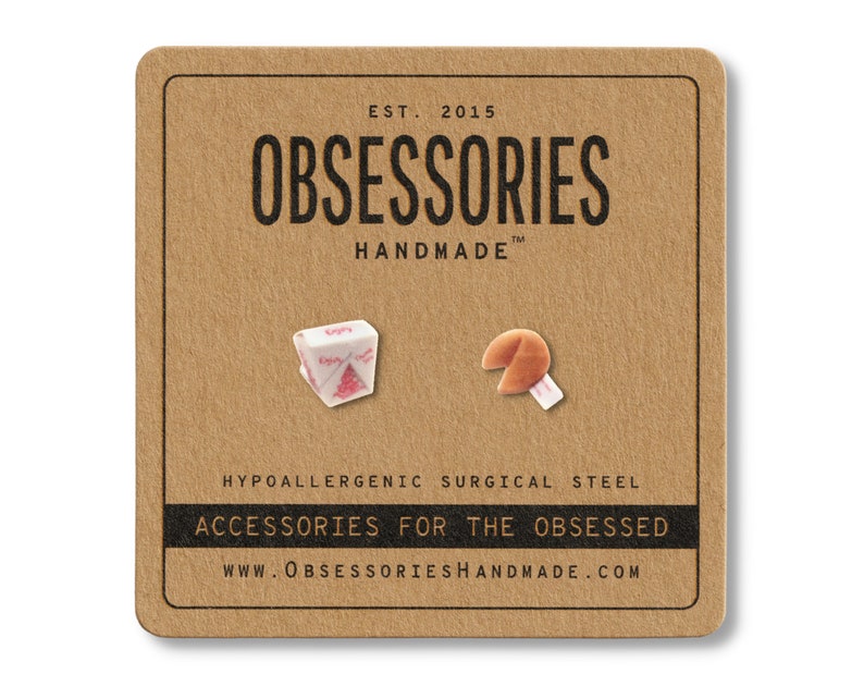 May include: A pair of novelty earrings on a brown card. One earring is a white and pink takeout container, the other is a fortune cookie with a white fortune. The card reads "OBSESSORIES HANDMADE" and "ACCESSORIES FOR THE OBSESSED."
