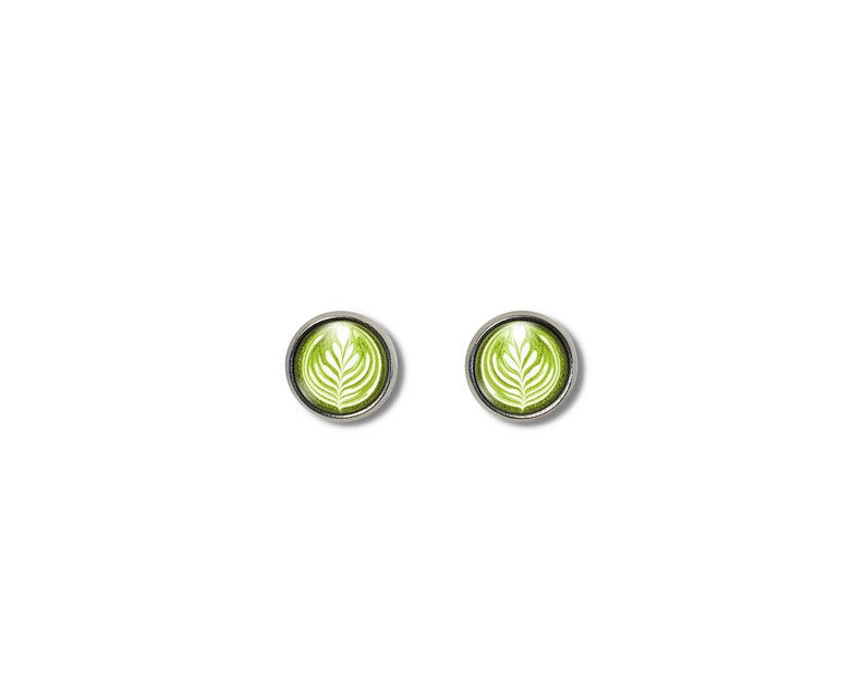 May include: A pair of silver stud earrings with a green and white latte art design.