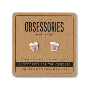 May include: A pair of white and pink Chinese takeout box earrings on a brown card. The card reads "OBSESSORIES HANDMADE" and "ACCESSORIES FOR THE OBSESSED". The earrings are made of hypoallergenic surgical steel.