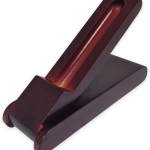 May include: A dark brown wooden pen holder with a hinged lid. The holder is open and the lid is propped up at an angle.