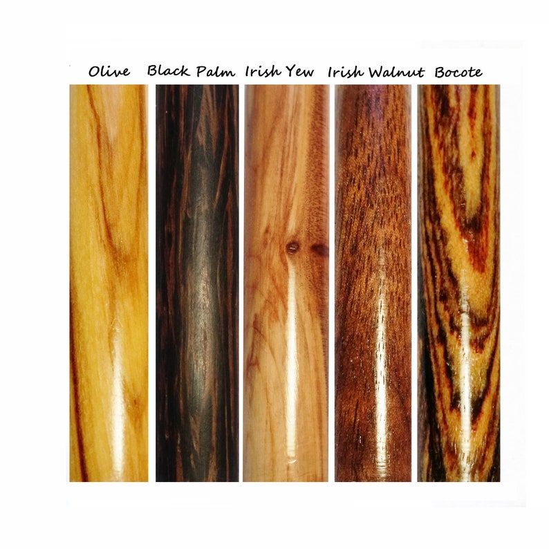 May include: Close-up of five different types of wood: Olive, Black Palm, Irish Yew, Irish Walnut, and Bocote. Each wood sample is a cylinder with a smooth, polished finish.