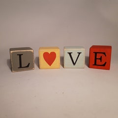Handmade wooden letter blocks spelling LOVE.