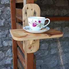 Handmade teacup bird feeder made from repurposed wood and charity shop teacup.