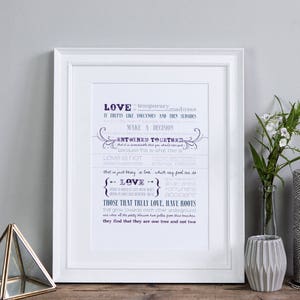 May include: A white framed print with a purple and blue text design that reads "LOVE is temporary,  it drifts like volcanoes and then subsides, make a decision, entwined together, that is just truly is love, which we feel one as LOVE, those that truly love, have roots that grow towards each other, understanding and give equally, blossom together,  and find that they are one tree and not two."