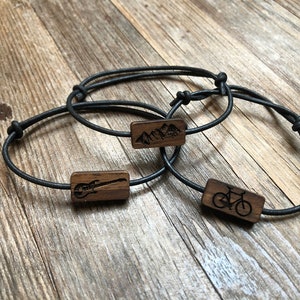 Bracelet with a wooden symbol placed on a leather strap