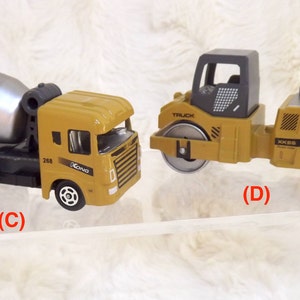 K&ouml;nnte beinhalten: Zwei Spielzeug-Baumaschinen, ein gelber Betonmischer-LKW mit einer silbernen Trommel und eine gelbe Walze mit einer grauen Kabine. Beide Fahrzeuge haben schwarze R&auml;der und den Text "KONG" an der Seite.