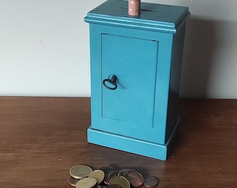 Vintage metal money box in the shape of a safe