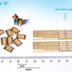 May include: A set of wooden crate kits for model building. The kit includes 10 small crates and 2 large crates. The crates are made of unfinished wood and are approximately 1 inch in size.