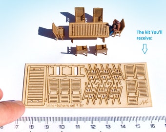 May include: A laser-cut wooden kit for building a miniature table and six chairs. The kit includes all the pieces needed to assemble the furniture, which is approximately 1 inch in size. The kit is labeled "table + 6 chairs set 1 87".