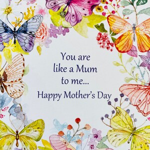 May include: A white card with a watercolor floral border and the text "You are like a Mum to me... Happy Mother's Day".