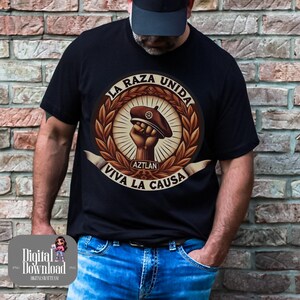 May include: A black t-shirt with a brown and white graphic design. The graphic features a raised fist holding a beret with the text "La Raza Unida" and "Viva La Causa" in a circle around the fist. The text "Aztlan" is also included in the graphic.
