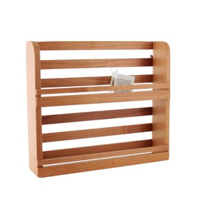 May include: A wooden spice rack with five shelves. The rack is made of light brown wood and has a natural finish.