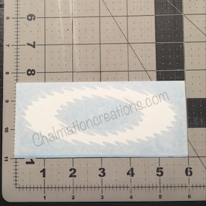 May include: A white vinyl decal with a blue background and a wavy design. The decal has the text "Chalmationcreations.com" printed on it.