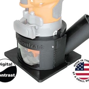 May include: A black router dust collection system with the text "Digital Contrast" and "Falcon Contrast". The system is attached to an orange and silver power tool. Includes a "Made in the USA by a small business" sticker.