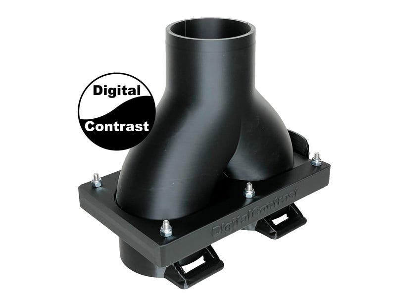 May include: Black plastic component with a Y-shaped design, mounted on a rectangular base. The base has mounting brackets and is secured with bolts. The text "Digital Contrast" is visible on the base and in a circular logo.