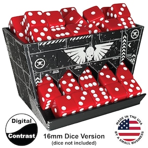 May include: A black plastic dice storage container with a white skull and wings graphic, featuring the text "FOR THE EMPEROR" and "DANGER HIGH POWER". The container holds numerous red six-sided dice with white pips. It is labeled as a 16mm dice version.