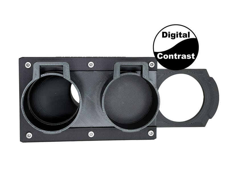 May include: A black 3D-printed camera accessory with two circular holders and a circular opening. The accessory has a rectangular base with mounting holes and the text "Digital Contrast" in a black and white circle.
