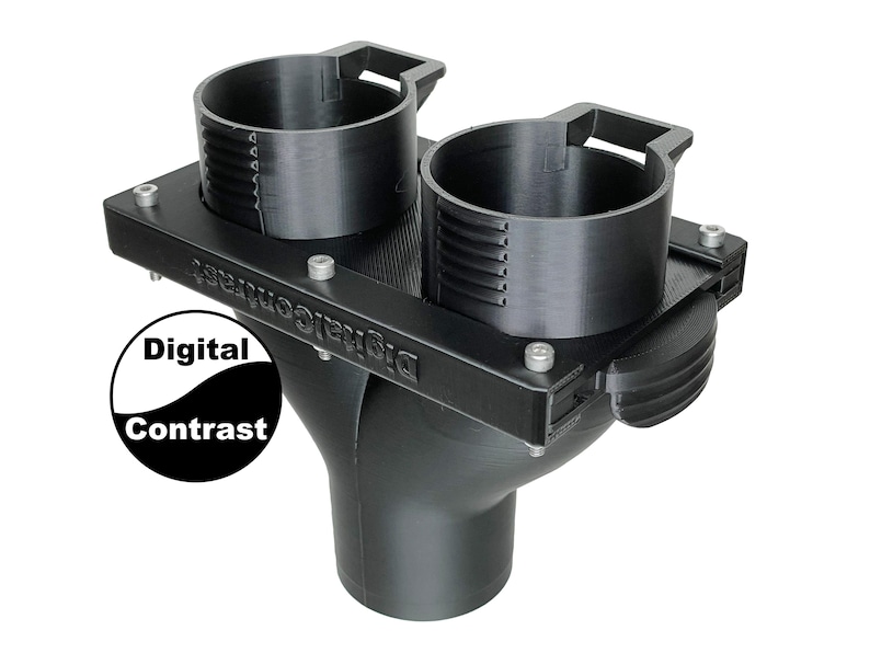 May include: A black 3D-printed object with two cylindrical cup holders and a funnel-shaped base. The object has the text "Digital Contrast" on its side and is secured with small screws. The cup holders have measurement markings.