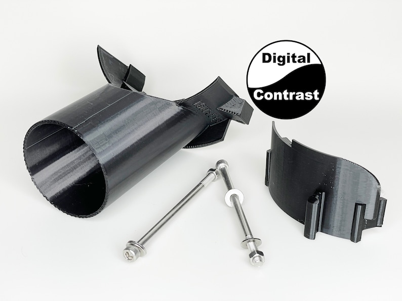 May include: A black 3D printed object with a cylindrical shape and a curved top. The object is attached to a black 3D printed base with two silver screws. The object is labeled "Digital Contrast".