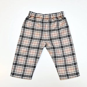 May include: Beige, black, and red plaid pants with an elastic waistband.