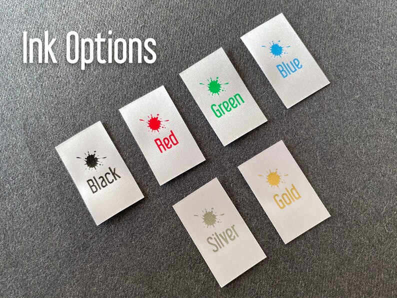 May include: Ink color options for a product, shown on small white fabric swatches. The colors are black, red, green, blue, silver, and gold.