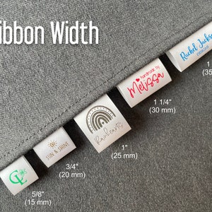 May include: White fabric labels with different ribbon widths in inches and millimeters. The labels feature various designs, including a rainbow, a sun and shine logo, a floral design, and text that says "handmade by Melissa" and "Rachel Jackson Designs".