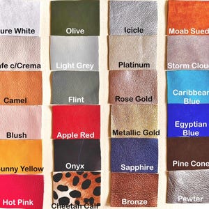 May include: A color chart of 20 different leather swatches. The swatches are arranged in four rows of five. The colors include: Pure White, Olive, Icicle, Moab Suede, Cafe c/Crema, Light Grey, Platinum, Storm Cloud, Camel, Flint, Rose Gold, Caribbean Blue, Blush, Apple Red, Metallic Gold, Egyptian Blue, Sunny Yellow, Onyx, Sapphire, Pine Cone, Hot Pink, Bronze, and Cheetan Calf.