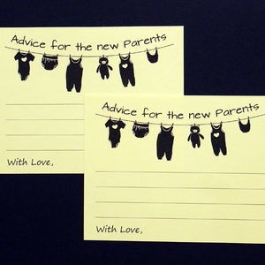 May include: Two yellow advice cards for new parents. Each card has the text "Advice for the new Parents" and a clothesline with baby clothes illustrations. The cards also include the text "With Love," and lined spaces for writing.