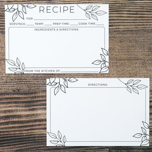 May include: Two white recipe cards with black leaf corner designs. The top card reads "RECIPE" and includes fields for servings, temperature, prep time, and cook time. The bottom card is for directions. Both cards have a blank space for writing.