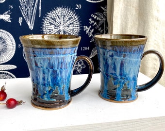 Handmade cup/mug individually thrown on the pottery wheel. Blue runny glaze with earthy tones. Scottish Landscapes, contemporary stoneware