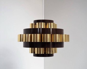 May include: A modern, mid-century style pendant light fixture with a layered design. The fixture features a dark brown metal base with gold metal accents.