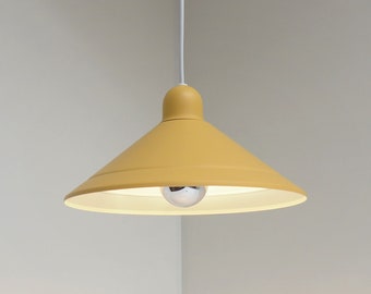 May include: A yellow pendant light with a white cord hanging from the ceiling. The light has a cone-shaped shade.