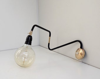 Vintage swing wall lamp made in solid brass with black plastic - Danish design lighting from the 1950s